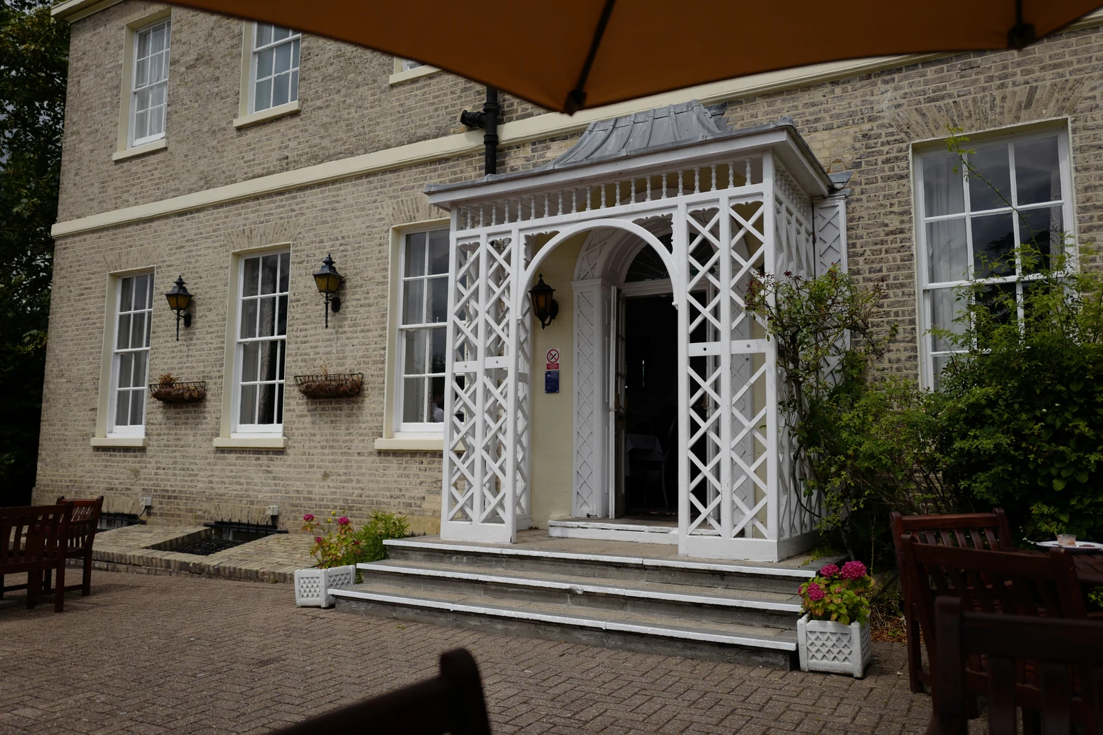 A stone building with a white entrance porch, photographed during the UK conference visit